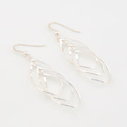 Silver tear-shaped earrings on a white background