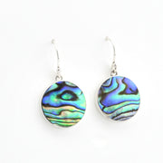 Abalone shell earrings on silver hooks against a white background