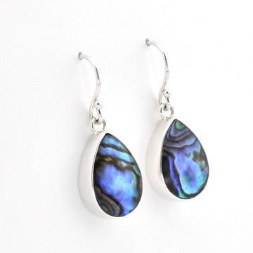 A pair of silver teardrop dangle earrings with iridescent abalone shell inlays showing blue, green, and purple hues, set against a plain white background.