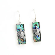 Pair of earrings with turtle design on a white background