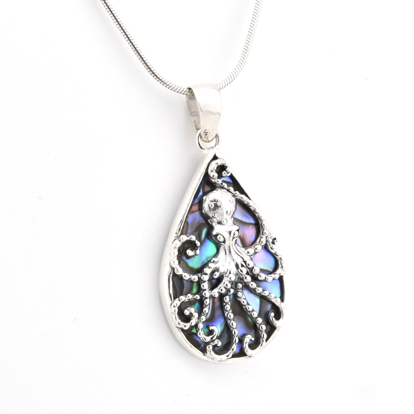 Teardrop-shaped pendant with intricate design on a white background