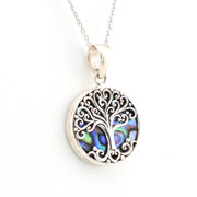 Silver tree of life pendant with abalone shell inlay on a white background