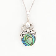 Silver pendant with a colorful central stone on a white background