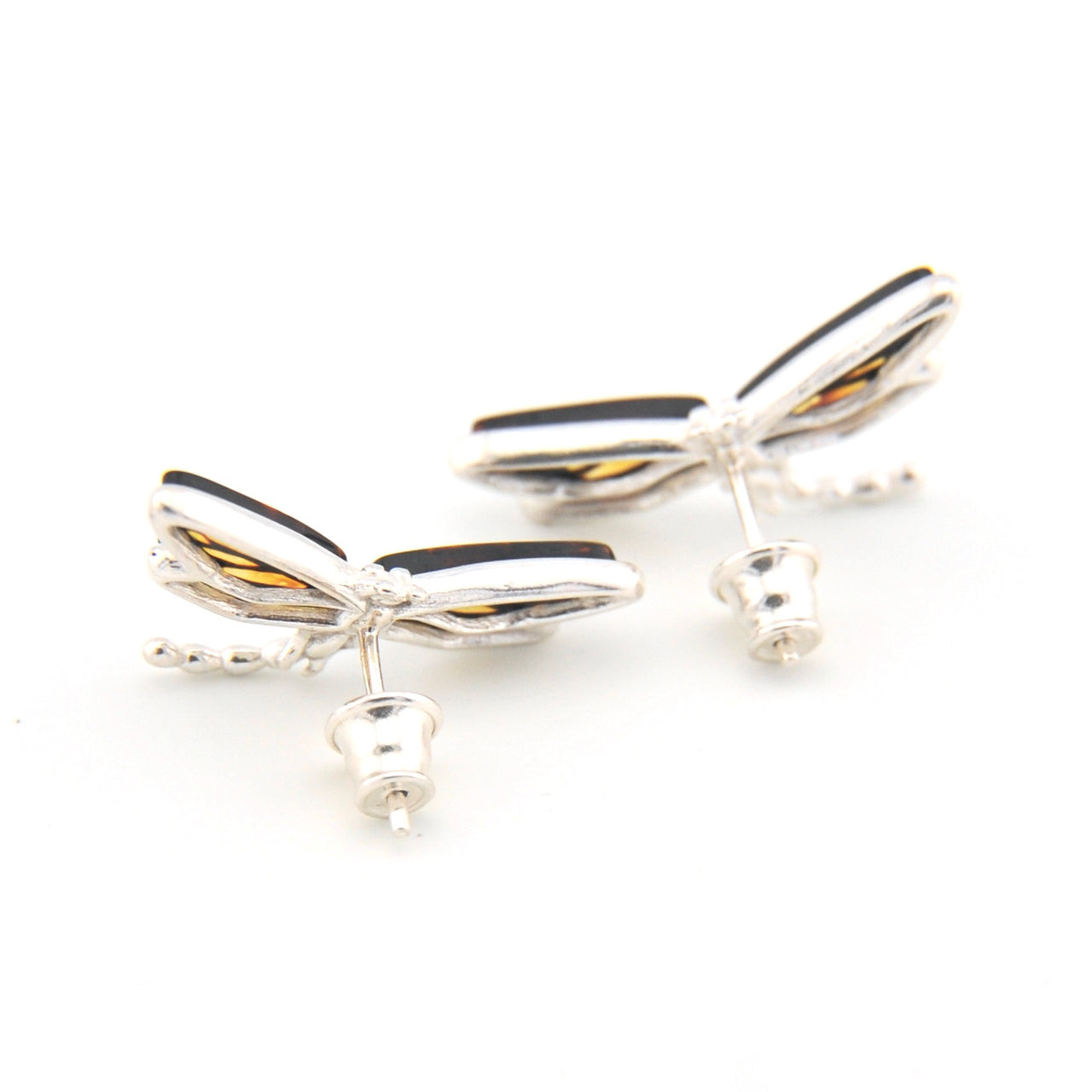 Silver dragonfly-shaped earrings on a white background