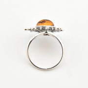 Silver ring with a wooden top on a white background