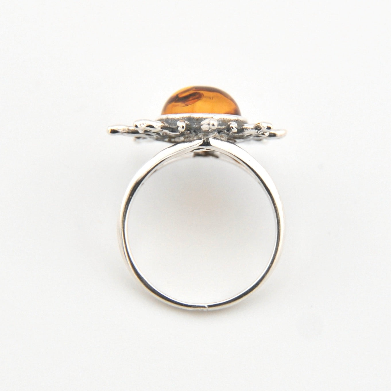 Silver ring with a wooden top on a white background