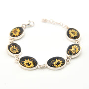 Bracelet with black and gold floral designs on a white background