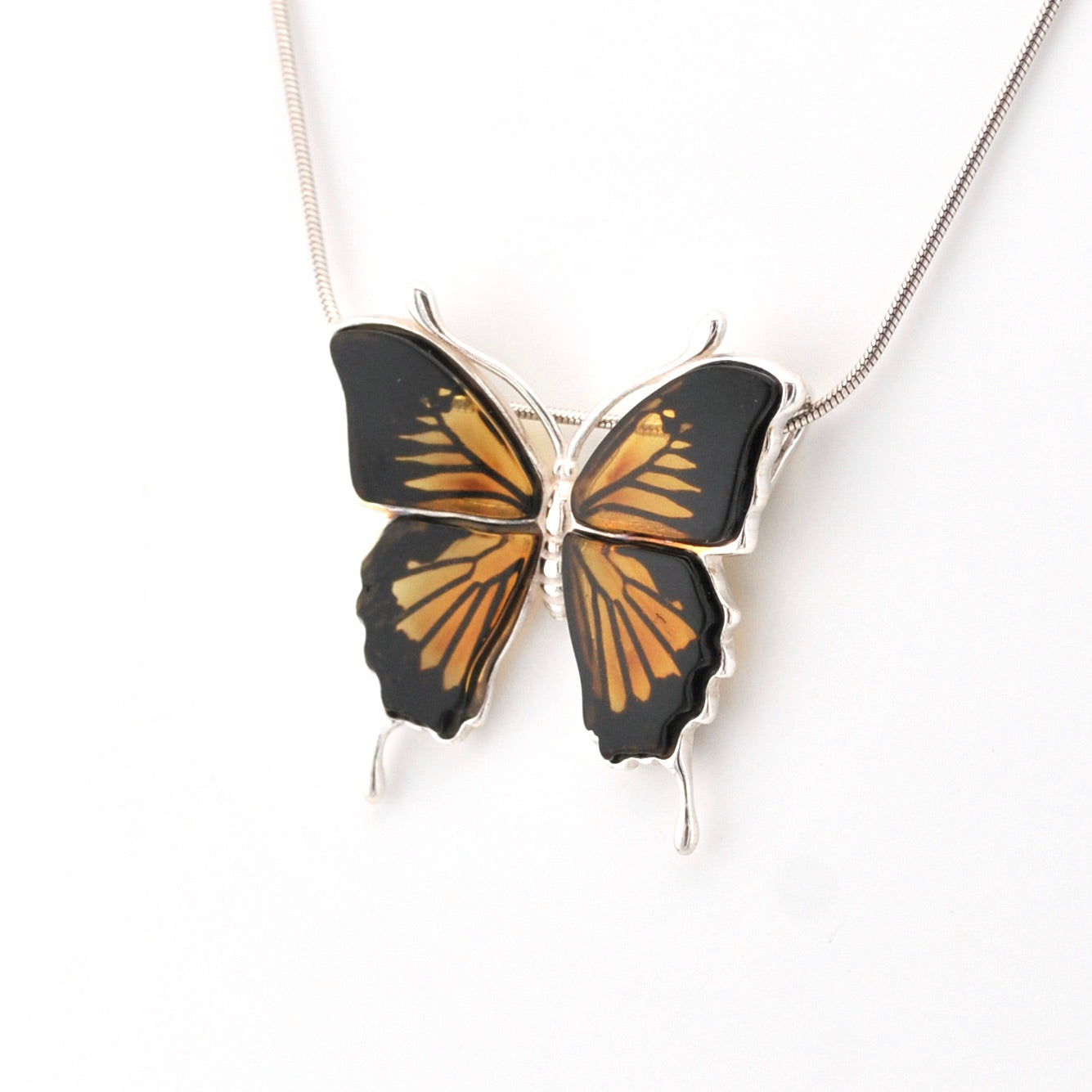 Butterfly-shaped pendant on a chain against a white background