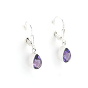 Silver earrings with purple teardrop-shaped gemstones on a white background