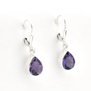 Pair of silver earrings with purple teardrop-shaped gemstones on a white background