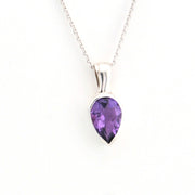 Purple teardrop pendant on a silver chain against a white background
