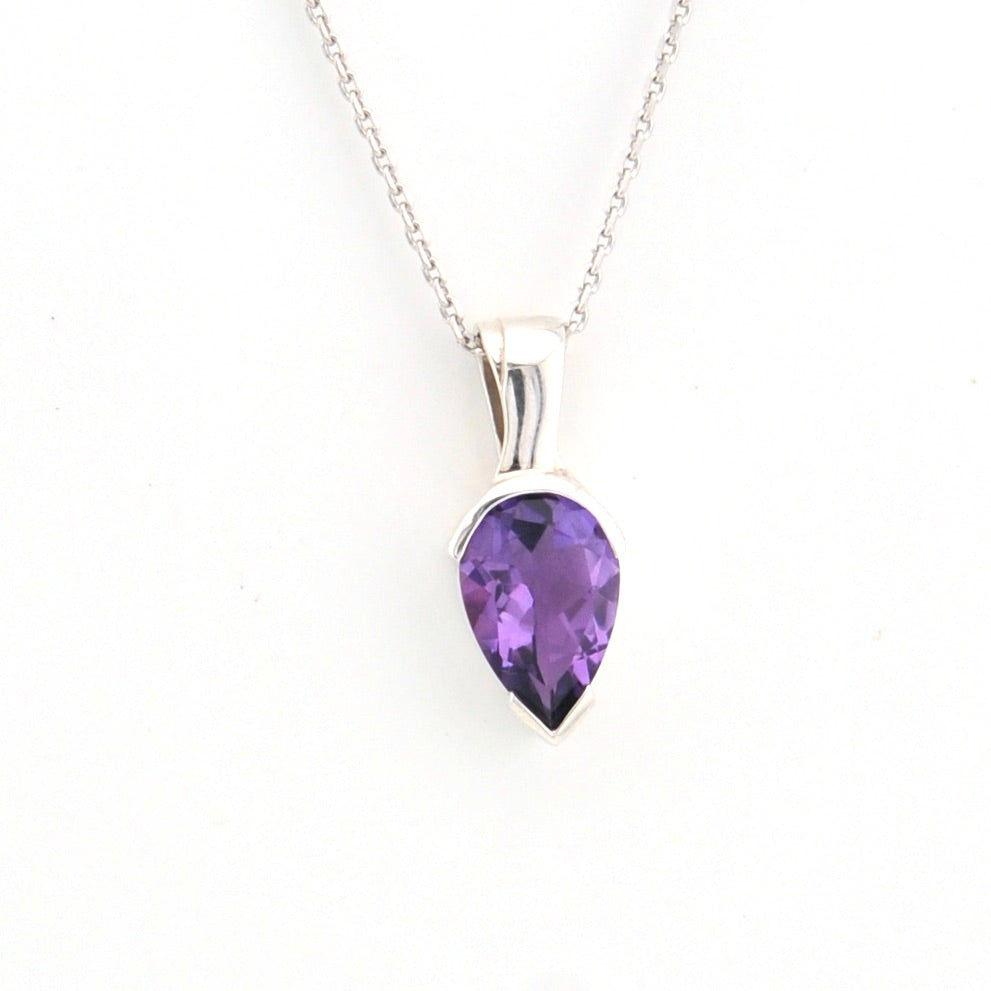 Purple teardrop pendant on a silver chain against a white background
