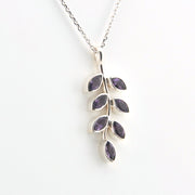 Silver necklace with purple gemstone leaves on a white background