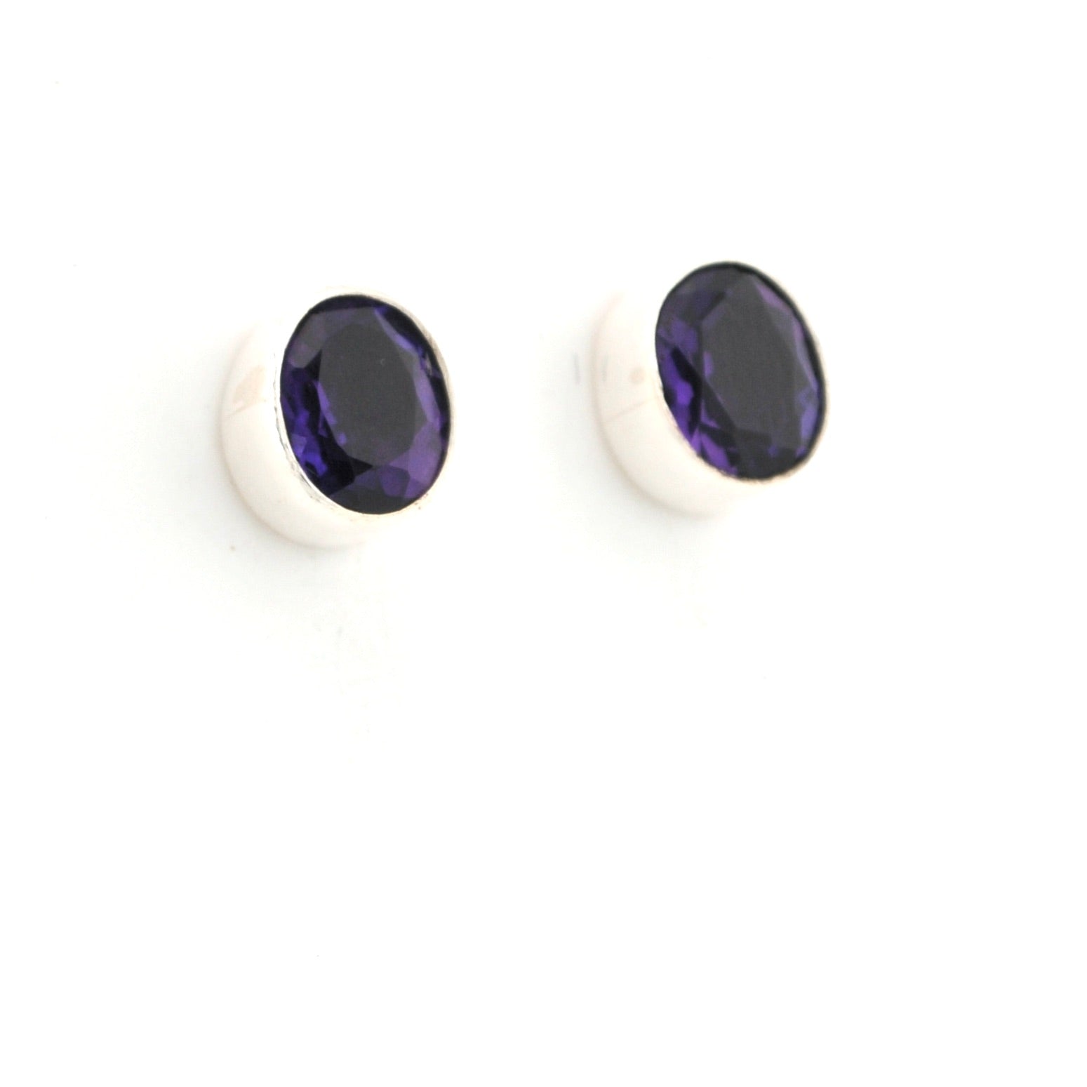 Pair of stud earrings with purple gemstones on a white background