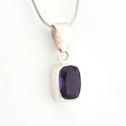 Silver pendant with a purple gemstone on a white background