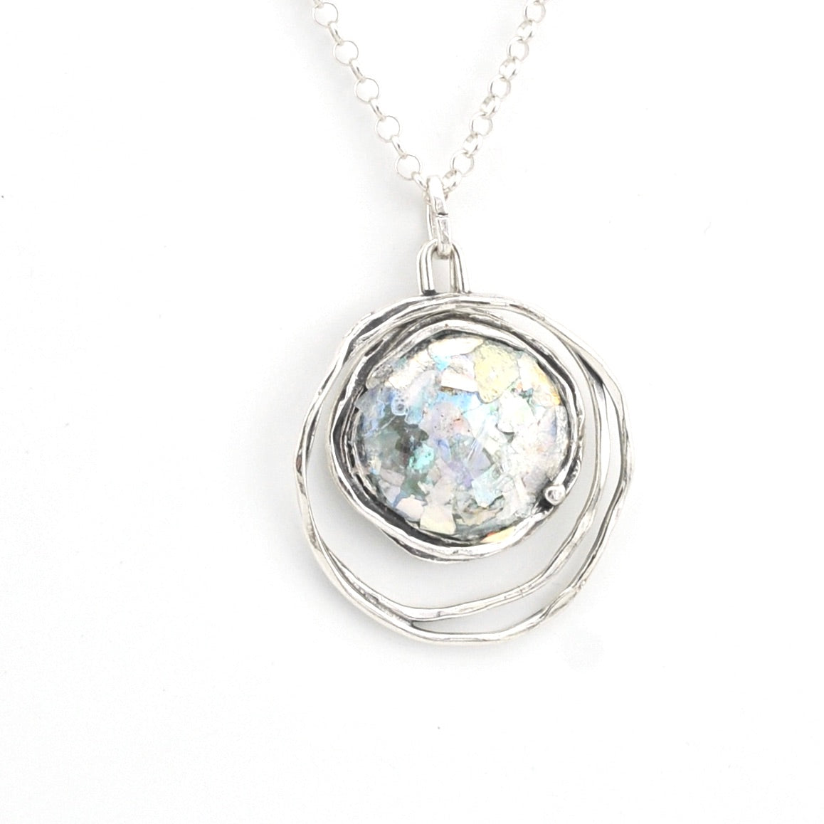 Silver necklace with a round pendant on a white background
