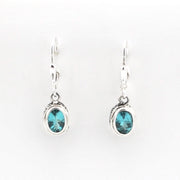 Silver earrings with blue gemstones on a white background