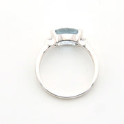 Silver ring with a large blue gemstone on a white background