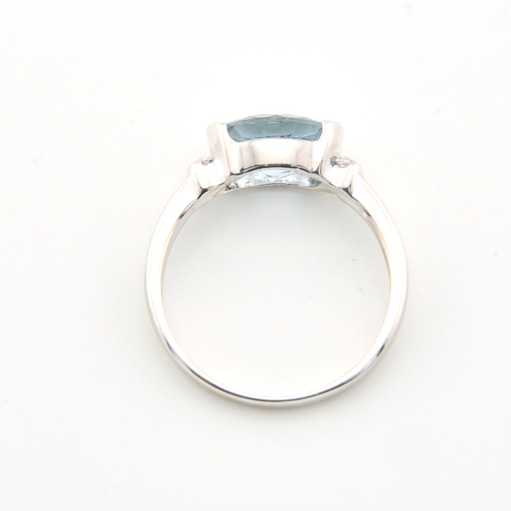 Silver ring with a large blue gemstone on a white background