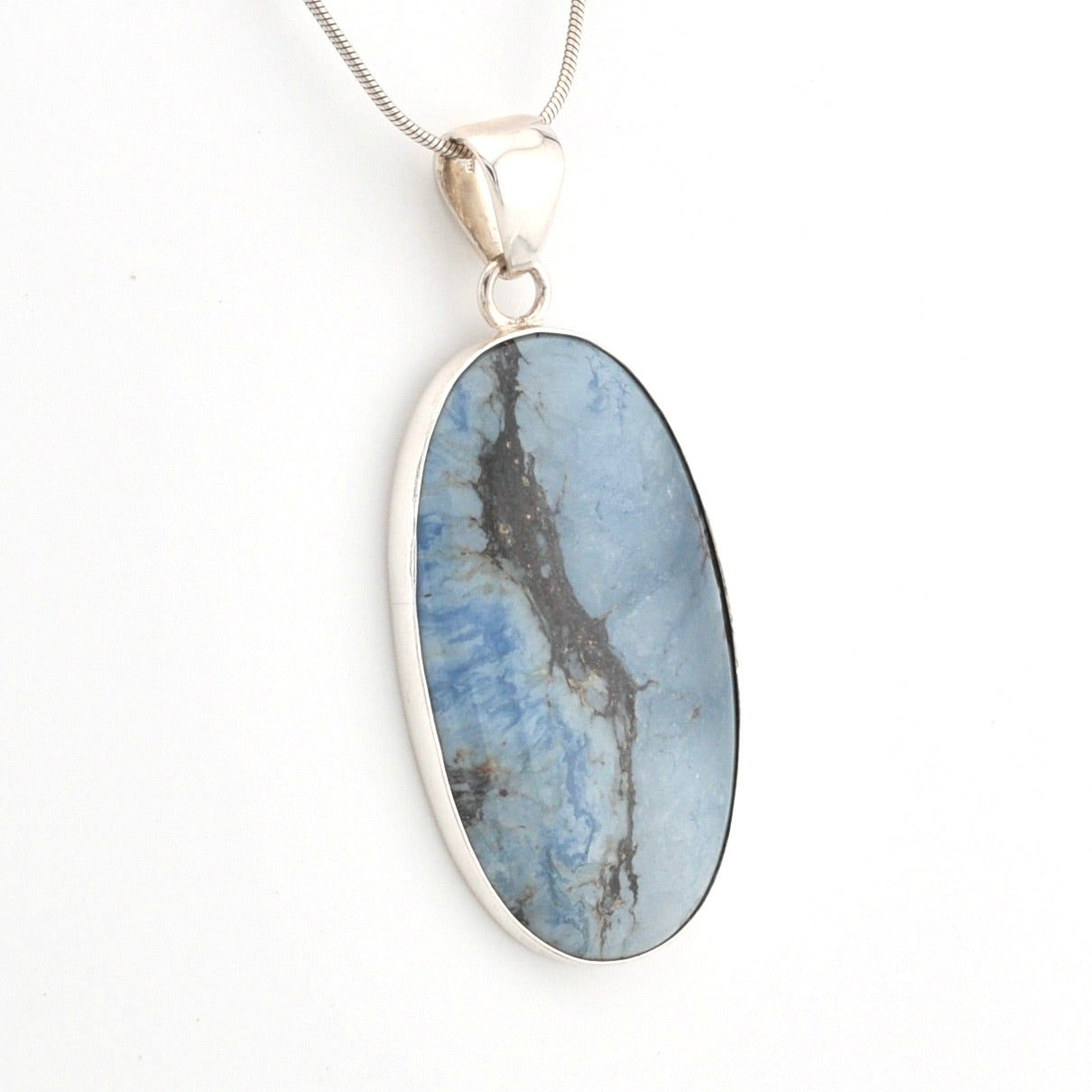 Oval-shaped blue stone pendant on a silver chain against a white background