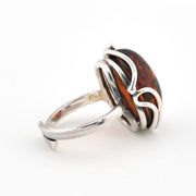 Silver ring with a amber on a white background