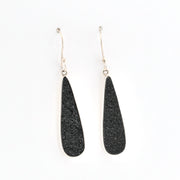 Black teardrop earrings on a white background