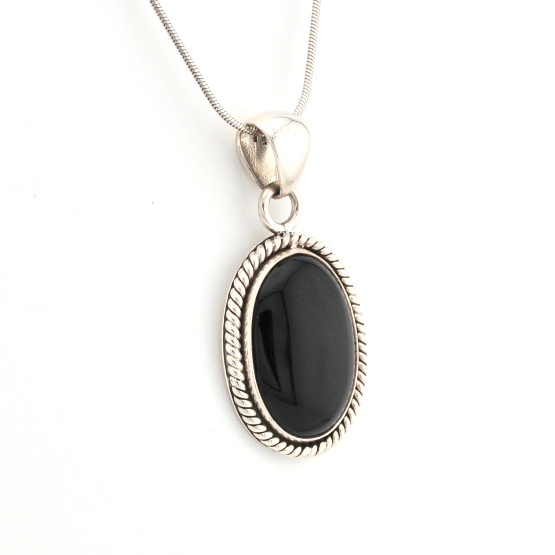 Silver necklace with a black pendant on a white background