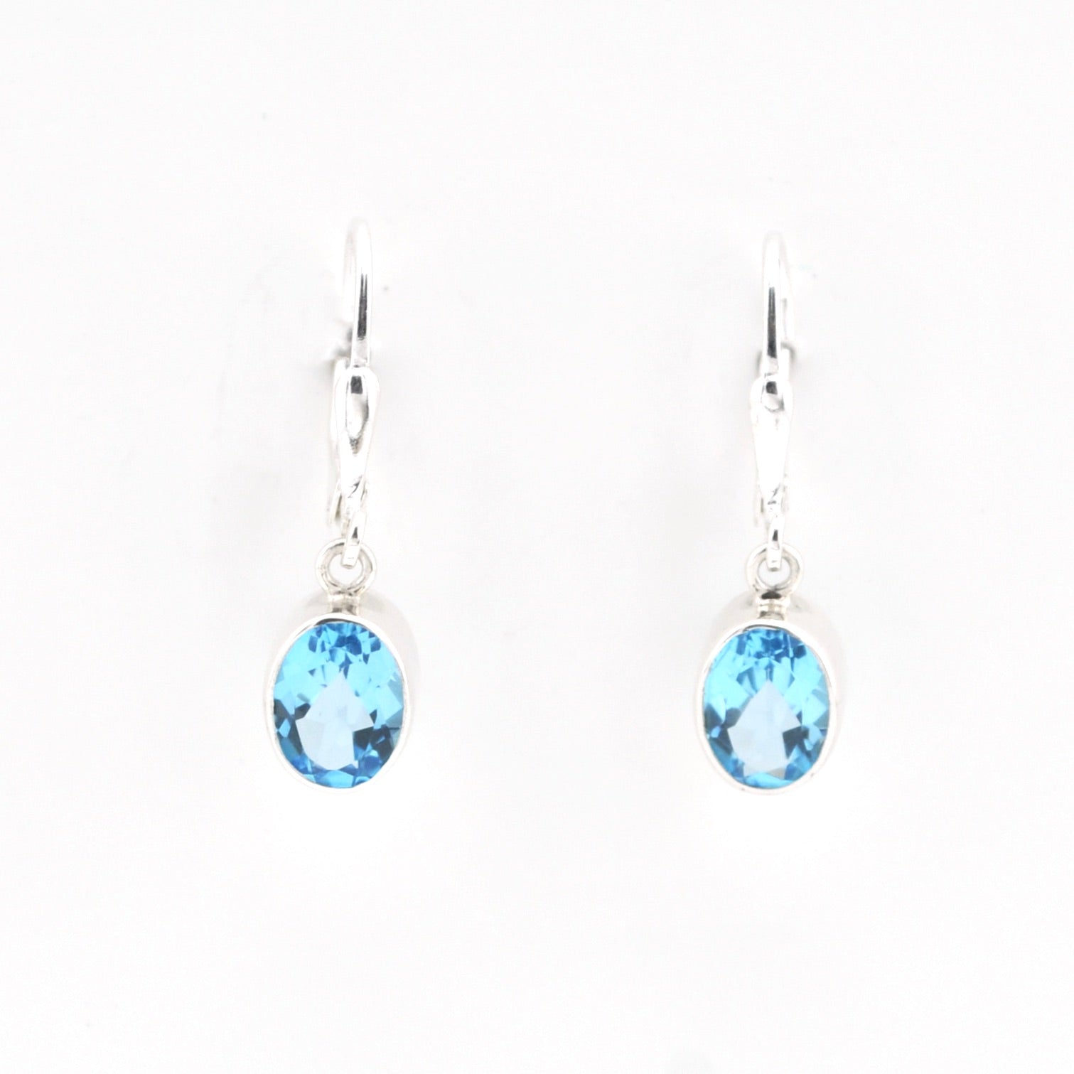 Pair of blue gemstone earrings on a white background
