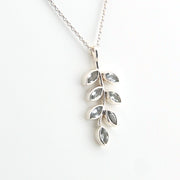 Silver leaf-shaped pendant necklace on a white background