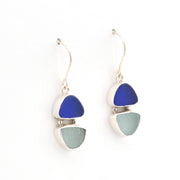 Pair of earrings with blue and gray triangular stones on a white background