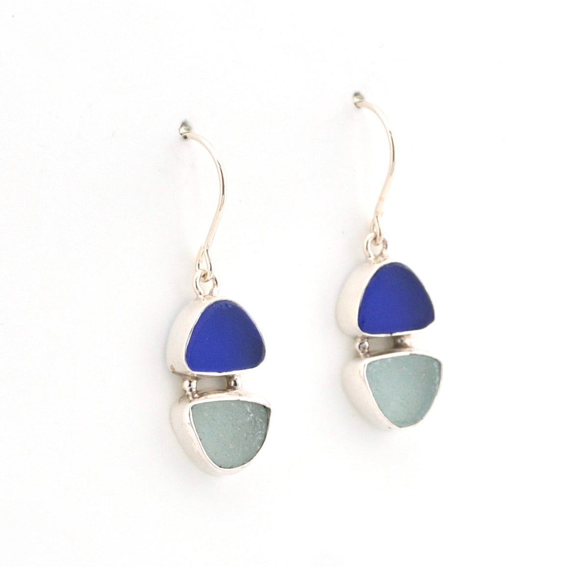 Pair of earrings with blue and gray triangular stones on a white background