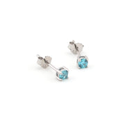 Pair of silver stud earrings with blue gemstones on a white background