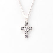 Silver cross pendant on chain.