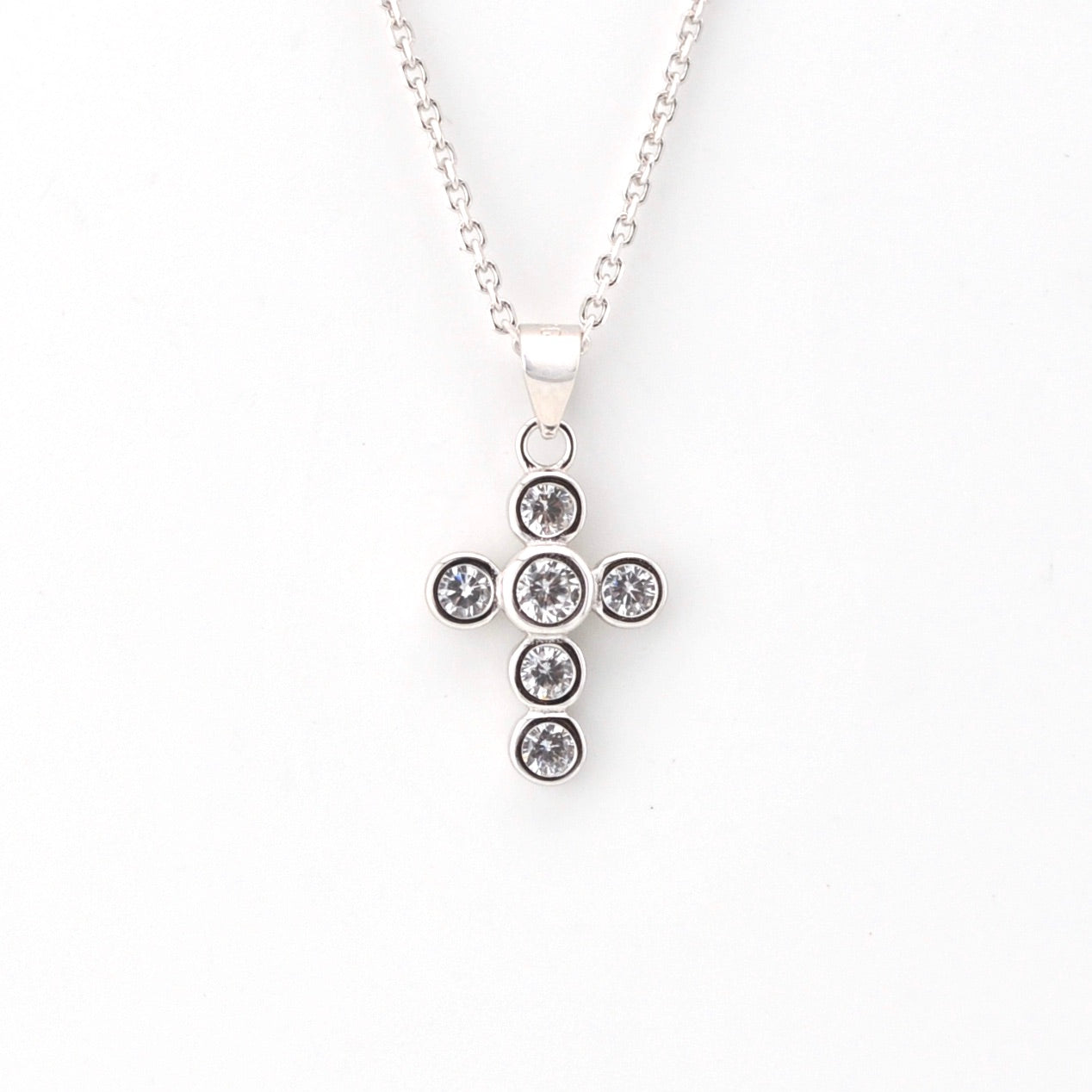 Silver cross pendant on chain.