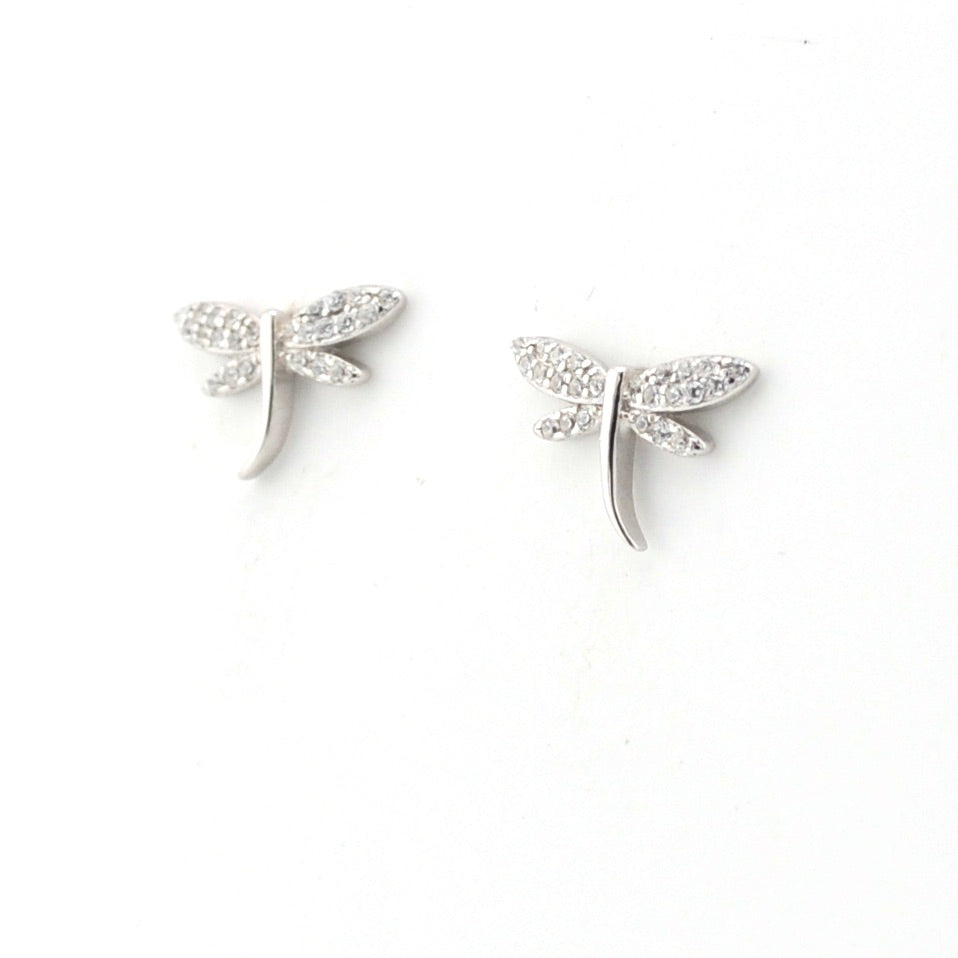 Silver dragonfly-shaped earrings on a white background