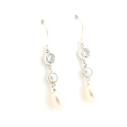 Pair of pearl and crystal drop earrings on a white background
