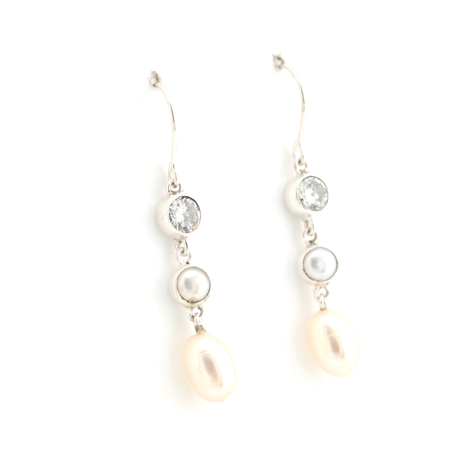 Pair of pearl and crystal drop earrings on a white background