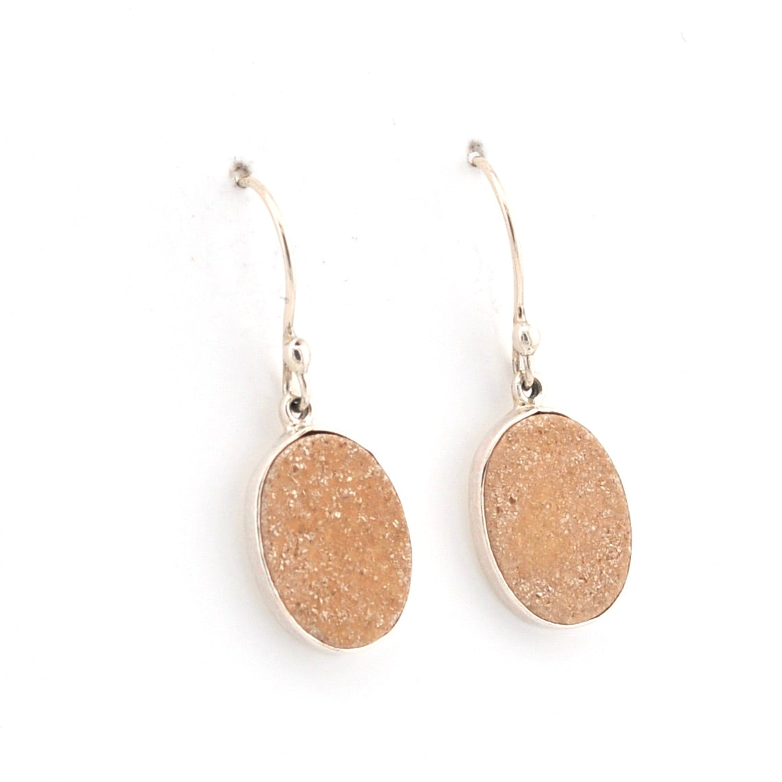 Pair of gold oval earrings on a white background