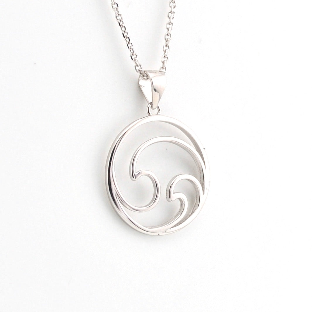 Silver pendant with a wave design on a white background