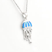 Jellyfish-shaped pendant with blue opal inlay on a white background