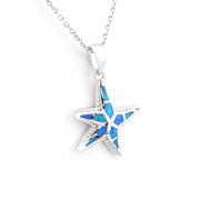 Star-shaped pendant with blue opal inlay and diamond on a white background