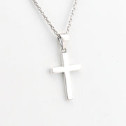 Silver cross necklace on a white background