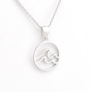 Silver wave pendant necklace on a white background