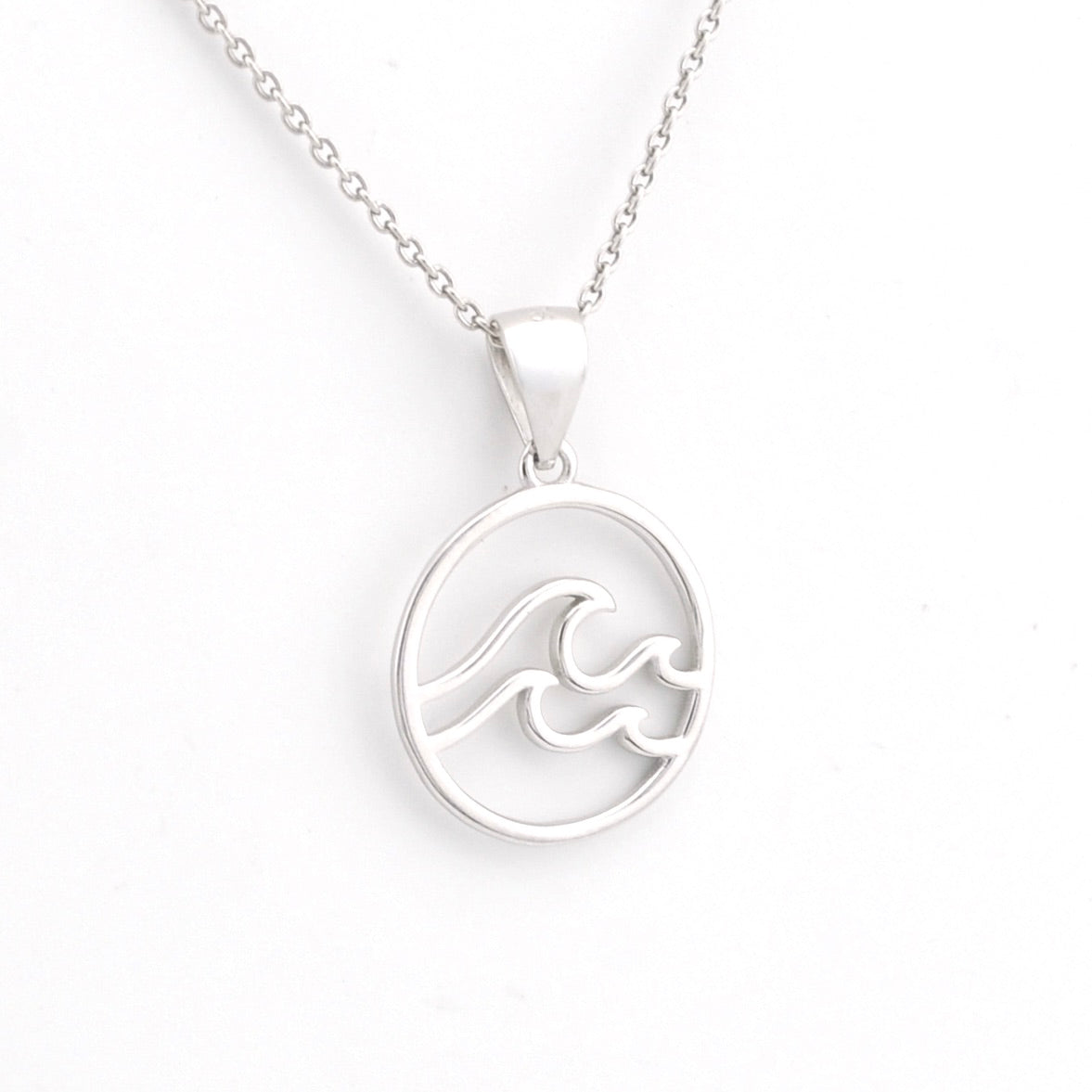 Silver wave pendant necklace on a white background