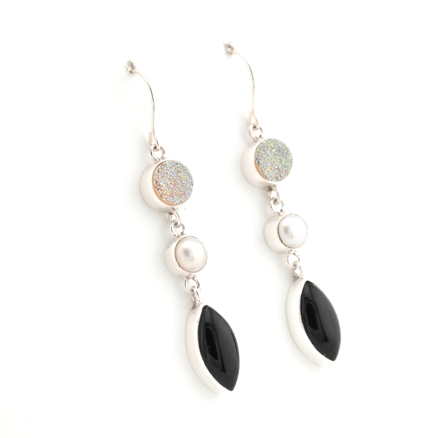 Pair of earrings with black and white stones on a white background