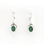 Pair of silver earrings with green gemstones on a white background