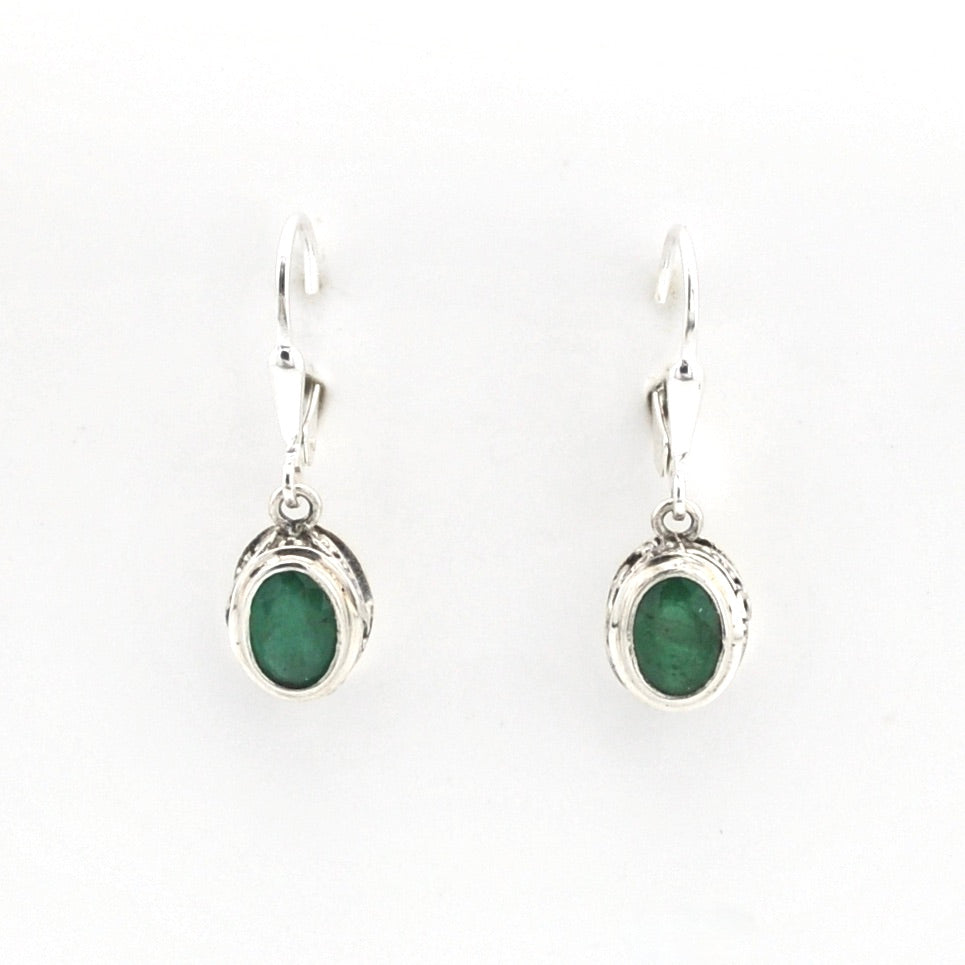 Pair of silver earrings with green gemstones on a white background