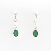 Pair of silver earrings with green gemstones on a white background
