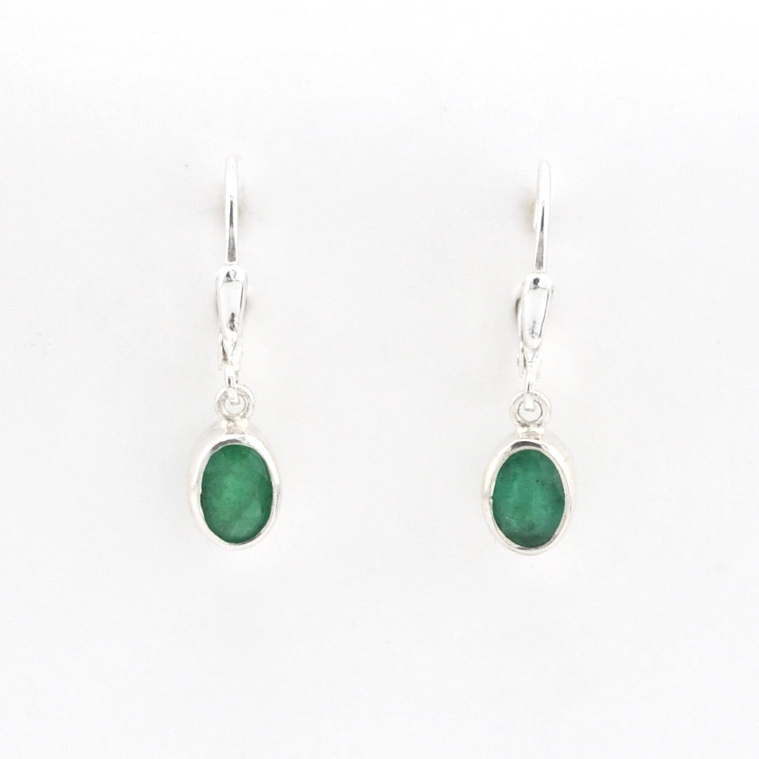 Pair of silver earrings with green gemstones on a white background