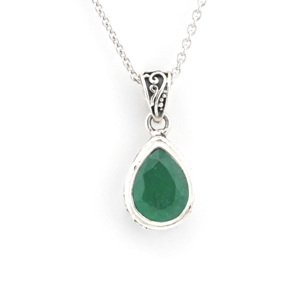Teardrop-shaped green gemstone pendant on a silver chain against a white background